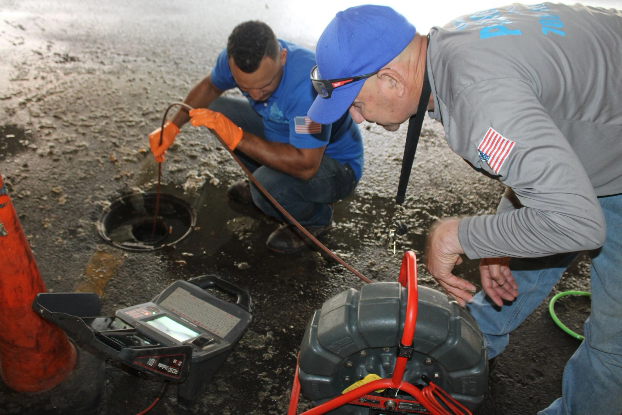 Morata Plumbing technicians running a sewer camera inspection through a cleanout in Miami to diagnose pipe damage